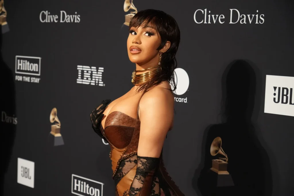 Cardi B with chocolate-toned mullet hairstyle in a brown leather outfit
