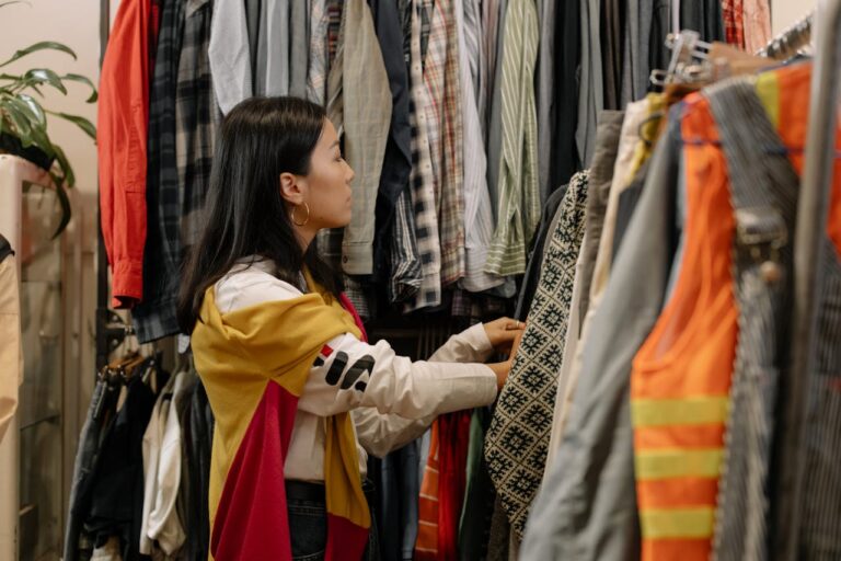 a girl is shopping in a thrift store, which is part of sustainable fashion