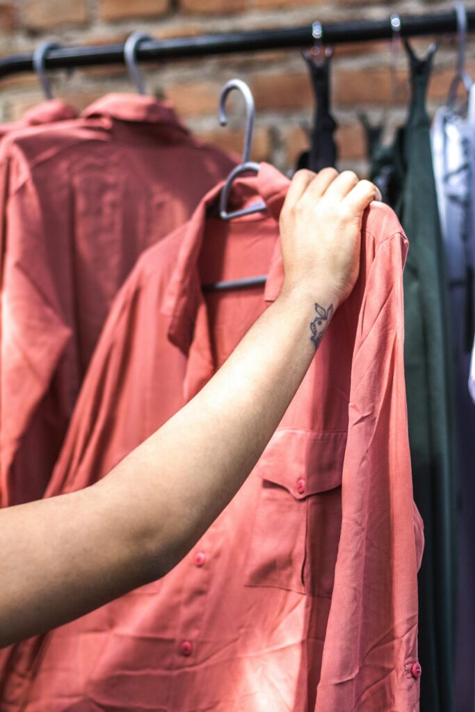 girl checking the quality of a shirt at a thrift store