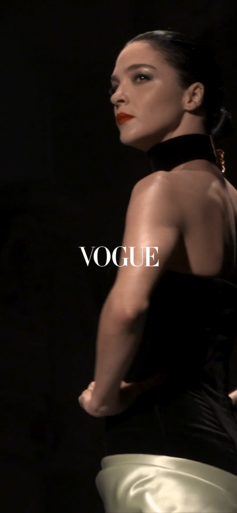 the opening when starting the vogue app, a model dressed in black and gold walking the runway